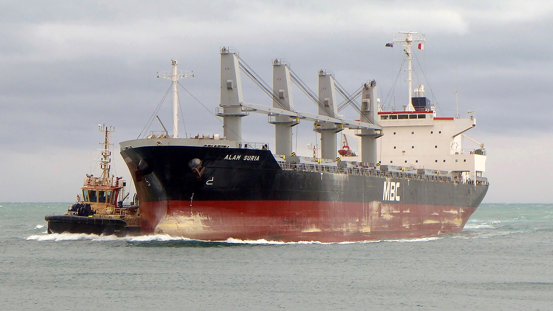 The geared bulk carrier Alam Suria entering Fremantle with a tug